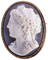 A VICTOIRAN HARDSTONE CAMEO AND GOLD BROOCH, CIRCA 1870 the cameo carved to depict a lady's head and