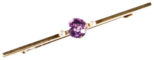 AN AMETHYST AND SEED PEARL BAR BROOCH, CIRCA 1890 the gold bar mounted with a central round cut