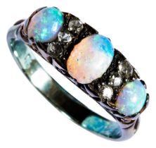 OPAL AND DIAMOND RING, CIRCA 1890 set with three oval cabochon-cut opals spaced by pairs of old