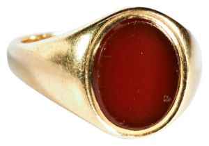 CARNELIAN SIGNET RING the oval carnelian plaque set in a gold mount Hallmarked for 18 carat gold