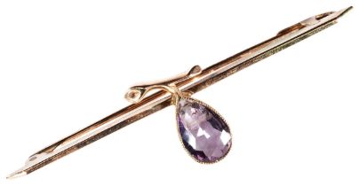 AN AMETHYST BAR BROOCH, CIRCA 1890 a gold bar mounted with a pear formed of a pear cut amethyst with