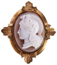 A VICTORIAN CARNELIAN AND GOLD BROOCH, CIRCA 1870 the oval cameo carved to depict the goddess