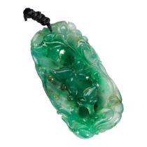 FINE JADEITE PENDANT Exquisitely carved with lotus blossoms, leafy tendrils and a toad Estimate on