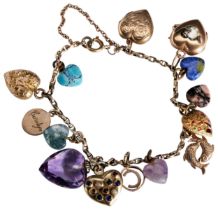 A GEMSET AND GOLD CHARM BRACELET the oval link bracelet suspending various heart shaped charms