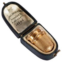 A VICTORIAN GOLD THIMBLE, CIRCA 1870 with recess for plaited hair and engraved 'E.M.R' In fitted