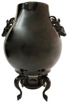 AN CHINESE BLACK-GLAZED DEER HANDLED HU-FORM VASE, 19TH/20TH CENTURY on an associated wood stand
