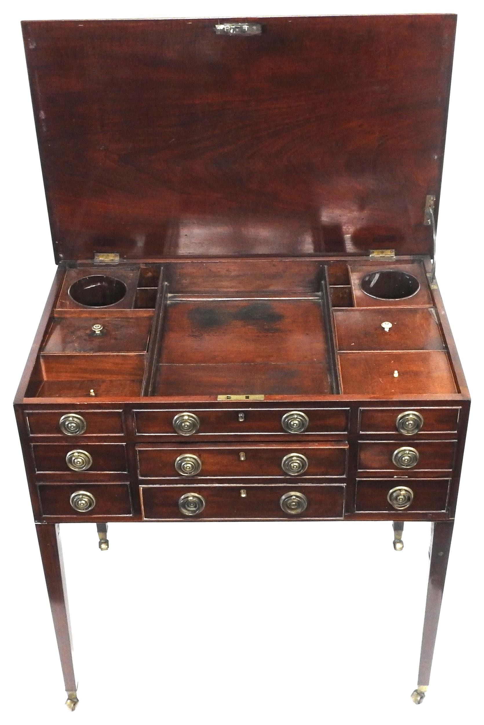 A LATE GEORGIAN MAHOGANY GENTLEMAN'S DRESSING TABLE, the hinged rectangular top opening to reveal an