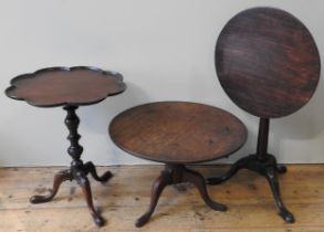 A VICTORIAN MAHOGANY TRIPOD TABLE WITH UNDULATING PIE CRUST EDGE, the tilting top on a knopped