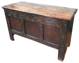 AN 18TH CENTURY OAK COFFER, the frieze panels with later scroll carved decoration, with three