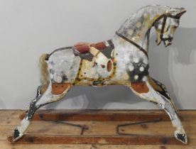 A VINTAGE HAND PAINTED CHILD'S ROCKING HORSE, CIRCA 1920, cream and black dapple finish, in need