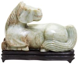 LARGE CARVED SOAPSTONE FIGURE OF A HORSE 20TH CENTURY modelled as the recumbent horse with head