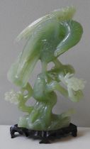 A CHINESE CARVED JADE MODEL OF AN EAGLE, LATE 20TH CENTURY, naturalistically modelled perched atop