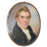 AN 18TH CENTURY PORTRAIT MINIATURE OF GENTLEMAN, in navy frock coat and frilled stock, hand