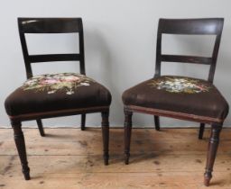 A SET OF SIX GEORGE III MAHOGANY DINING CHAIRS, curved top rail and splat above floral needlepoint