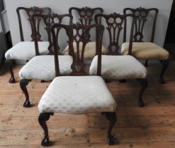 A SET OF SIX GEORGE III MAHOGANY DINING CHAIRS, in the Chippendale manner, curved top rail over