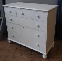 A CREAM PAINTED CHEST OF DRAWERS, 20TH CENTURY, comprised of three short drawers over three long