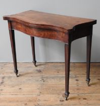 A 19TH CENTURY MAHOGANY TEA TABLE, serpentine form fold over pivoting top, raised on slender