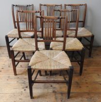 A SET OF SIX 19TH CENTURY COUNTRY CHAIRS, baluster turned top rail above a slatted back panel,