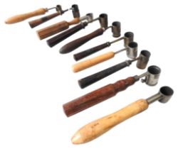 A GROUP OF TEN VINTAGE GUNPOWDER MEASURES, mostly French, some with adjustable cups, all with turned