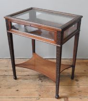 A LATE 19TH CENTURY MAHOGANY BIJOUTERIE TABLE, with profuse scroll foliate carved decoration