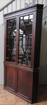 A LARGE 19TH CENTURY MAHOGANY CORNER CABINET, the top section with a dentil cornice over to astragal