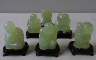 THREE SETS OF CHINESE CARVED JADE FIGURES, LATE 20TH CENTURY, raised on hardwood stands, with fitted