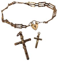 A GOLD GATE BRACELET AND TWO CRUCIFIX PENDANTS, the gate bracelet and larger pendant both marked .