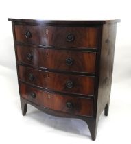 AN EARLY 20TH CENTURY MAHOGANY BOW FRONT CHEST OF DRAWERS, of compact proportions, comprised of four