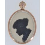 9ct gold double sided silhouette portrait pendant with a young lady on one side and a gentleman vers