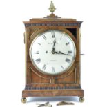 Wooden cased clock by Westwood London with ornate fretwork, brass ball feet, key present, fusee move