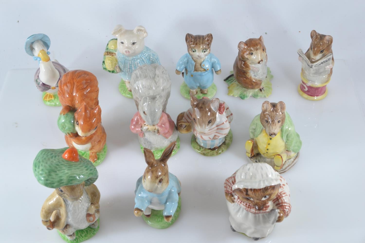 Twelve Beswick Beatrix Potter characters including Tom Kitten, Mrs. Tiggywinkle and Benjamin Bunny,