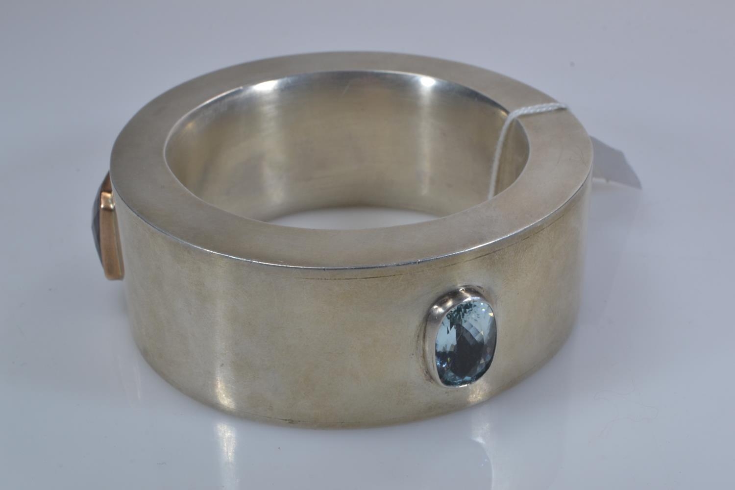 Custom made heavy white metal statement bangle, bezel-set with three large topaz stones, including b