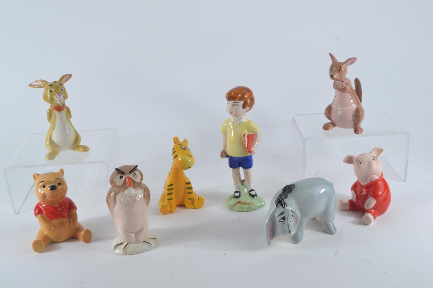 Eight Beswick Winnie the Pooh characters comprising Christopher Robin, Winnie the Pooh, Tigger, Pigl