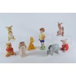 Eight Beswick Winnie the Pooh characters comprising Christopher Robin, Winnie the Pooh, Tigger, Pigl