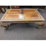 Indian style panelled low table, with inset flower marquetry, raised on carved cabriole legs. W76cm