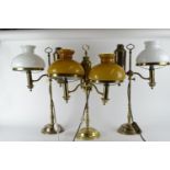 Three imitation converted brass oil lamps with faux storage vessels, tallest 56cm high