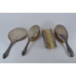 Three silver dressing table brushes, Daniel Manufacturing Company, Birmingham 1924, together with a