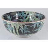 Chinese C19th famille noire bowl with bamboo design, blue marks to base, D24.5cm H11cm