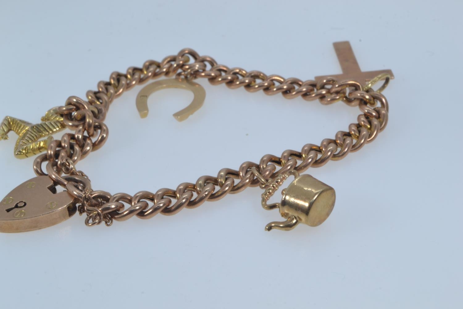 9ct rose gold bracelet with a heart-shaped padlock clasp, suspending four charms, including three 9c - Image 3 of 6