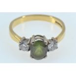 18ct gold, dark green tourmaline & diamond ring, the tourmaline top measuring 8x6mm, the two diamond