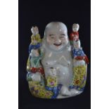 A Chinese porcelain famille jaune figure of a seated Buddha, with five children, with oval seal mark