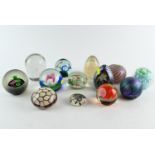 A collection of  fourteen paperweights inc. iridescent, millefiori, captive bubble with some signed