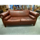 Large Leather 2/3 seater sofa with wooden trim and feet in a chestnut brown finish. W210 D 120 H88 c