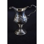 George III silver pedestal cream jug, maker's mark unclear, London 1783, later embossed with foliate