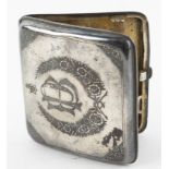 Iraqi white metal and niello cigarette case, the cover decorated with a harbour scene, the base with