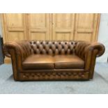 Modern two seater leather chesterfield field sofa in brown with castors. W163 D85 H70 cm approximate