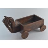A child's handmade rustic cart with a decorative Tang horse style head, a mahogany drawer 'cart' and