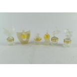 Six Lalique miniature scent bottles, some with contents, one glass