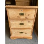 Stripped pine three drawer chest with brass campaign style handles. W58 x  D47 x H79