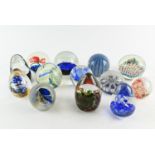 Collection of thirteen paperweights inc. millefiori with latticino star design, some signed